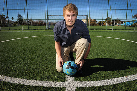 Lasting bond: David Jenkins' master's dissertation investigates social cohesion engendered by the 2010 FIFA World Cup South Africa. (He was photographed at UCT's artificial grass soccer pitch, first laid shortly before the 2010 FIFA World Cup.)