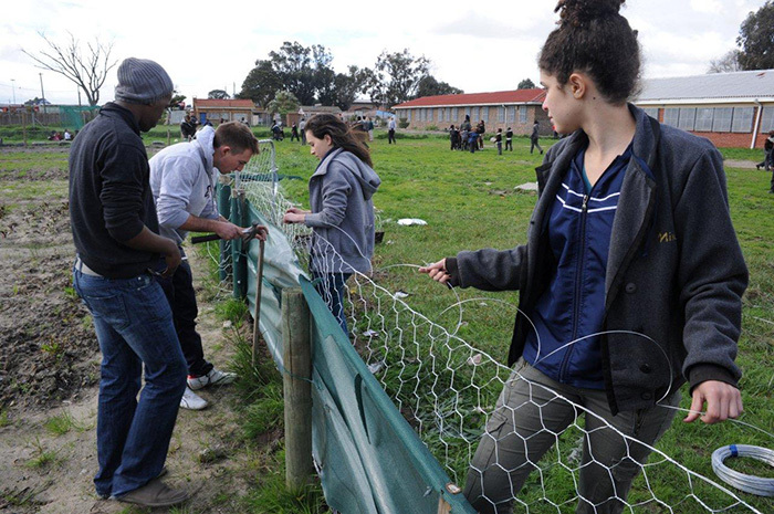 All out for Madiba: UCT students at the Walter Teka Primary School in Nyanga, where they put up a garden fence, painted toilet walls and played sports with the school's students as part of their Mandela Day 2013 contribution.