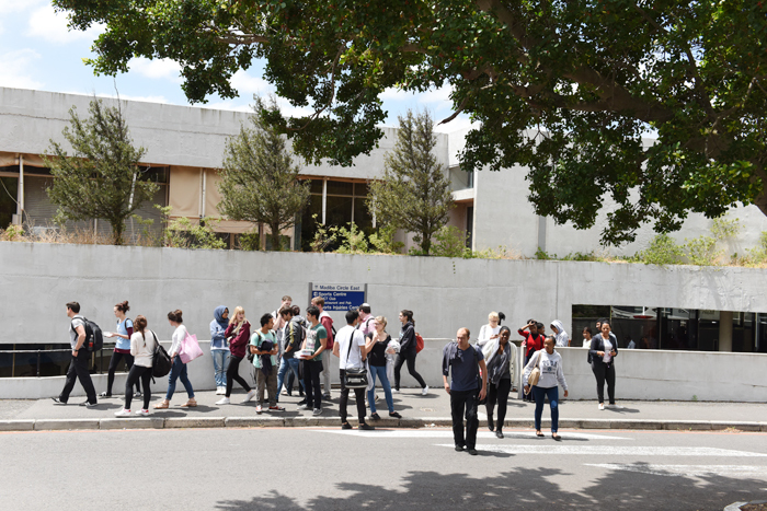 Students leave UCT's sports centre after writing their PGDA exam.