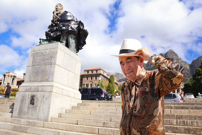 Activist and former Constitutional Court justice Albie Sachs next to the Rhodes statue on UCT upper campus. (Photo by Je'nine May.)