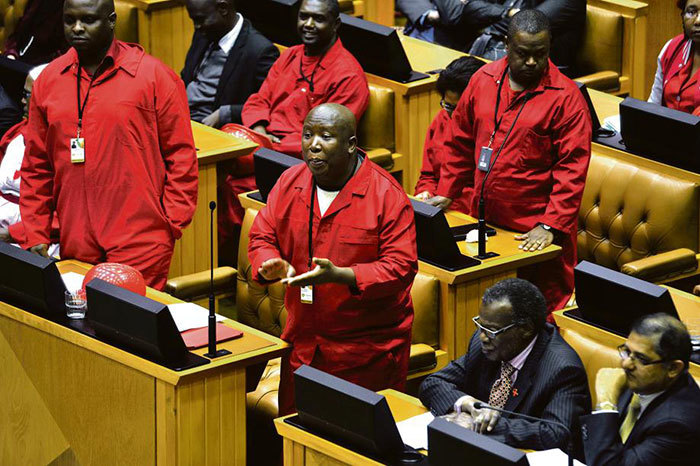 Leader of the Economic Freedom Fighters Julius Malema gets animated in his interaction with ANC MPs across the floor from him in the National Assembly.