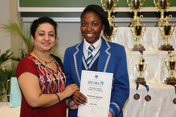 Saturday School learner from Wynberg Girls High School, Namusuma Kapenda, received three distinctions in her final matric exams. Prior to writing matric Kapenda did extremely well in SHAWCO's preliminary testing and is congratulated by Thara Kallungal, Academic Interventions Project Coordinator at the 2014 SHAWCO Shine Graduation.