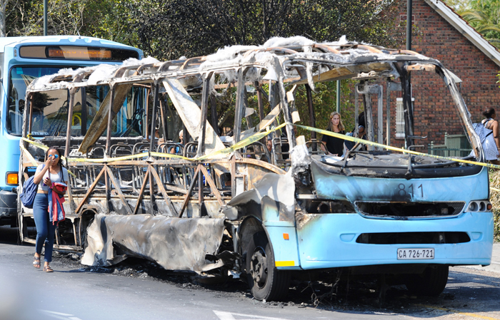 Violence must fall: The skeleton of a Jammie Shuttle, torched during Tuesday night's campaign of vandalism and intimidation.
