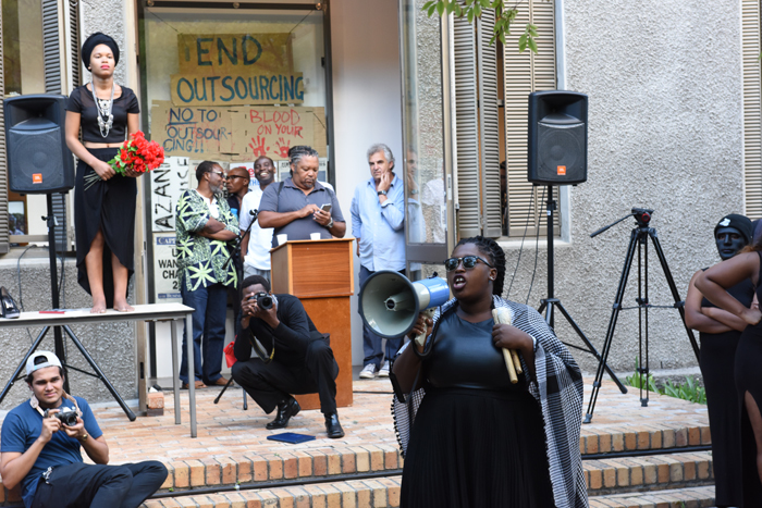A Rhodes Must Fall leader addresses the crowd outside the CAS Gallery after an exhibition jointly curated by RMF and the Centre for African Studies was stopped by a group of protesting students.