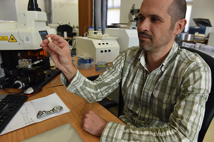 Dr Petrus le Roux, the head of geological sciences' radiogenic isotope laboratory, examines a molar that likely belonged to French artist Paul Gauguin.