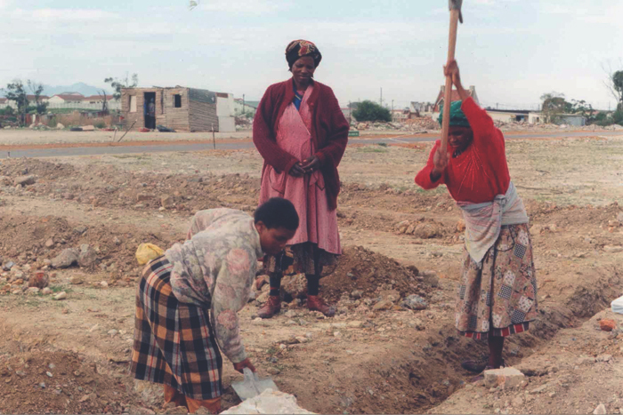 Women of Victoria Mxenge digging the first foundation.