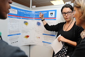 Alida Chevalier, a PhD student in the linguistics section of the School of African and Gender Studies, Anthropology and Linguistics (AXL), shows visitors at the UCT Postgraduate Research Expo her prize-winning poster on her research into reverse vowel shifts in South African English.