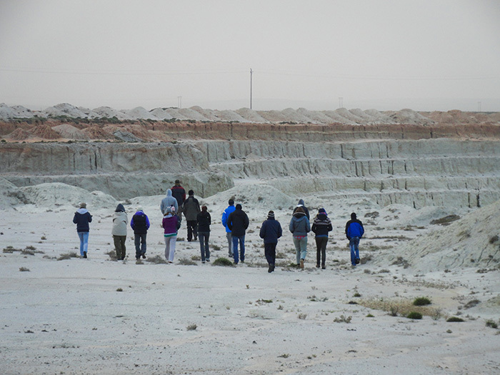 MSc students venture into a wasteland created by open-cast pit diamond mining along the Namaqualand coastline. They are part of the Namaqualand Restoration Initiative, a community-focused project to rehabilitate this fragile ecosystem. Image by Carina Bester.