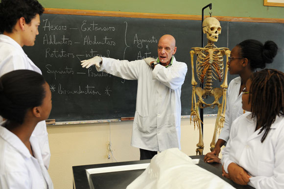 Teacher on the table: Prof Graham Louw with a group of second-year MBChB students in the dissection laboratory. Students dissect bodies donated to UCT, although some are unclaimed - those of the homeless, paupers or prisoners.