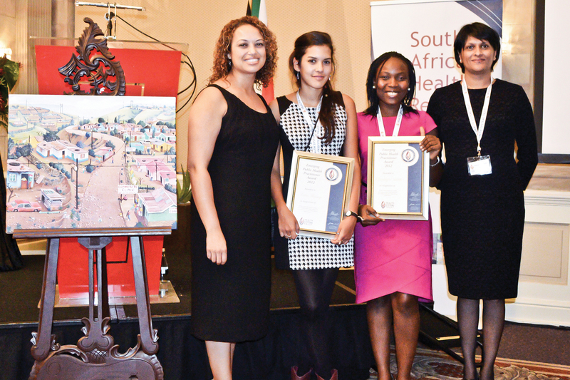 The winners of the Emerging Public Health Practitioners Award for 2012, Nadia Hussey and Oluwatoyin Adeleke, flanked by the editors of the South African Health Review, Rene English (on far left) and Ashme Padarath (far right).