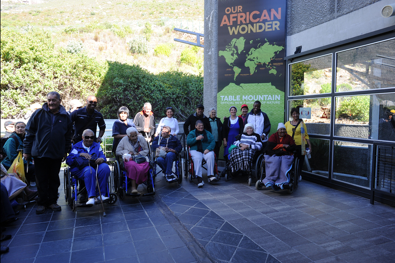 Up and away: Residents of Rehoboth Age Exchange and GH Starke homes for the aged in Hanover Park enjoyed a trip to the top of their world, thanks to UCT physiotherapy students and their supervisor in the Division of Physiotherapy, and the Table Mountain Aerial Cableway.