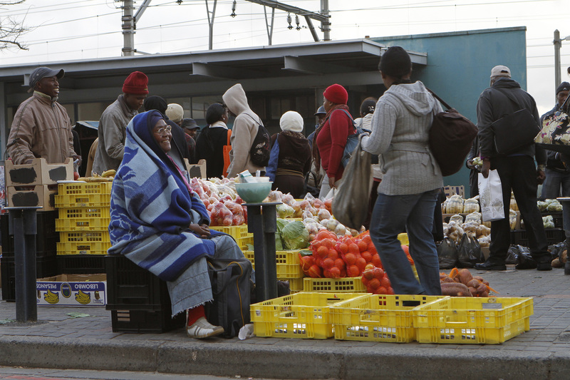 Commuters approach the Wynberg taxi rank in Cape Town on their way home. Informal traders capitalise on the passing trade. 
