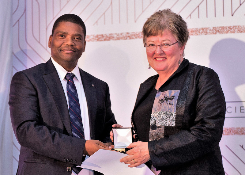 Prof Anna-Lise Williamson receives her award from Prof Jeffrey Mphahlele, vice-president of the SA Medical Research Council (SAMRC)