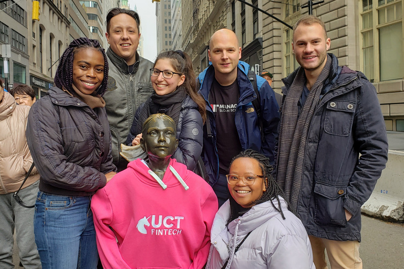 AIFMRM MPhil in Financial Technology students in New York, co-opting the bronze statue, Fearless Girl, into their class. In the picture are (from left) Masego Modibane, Aidan Fourie, Ashleigh Favish, Assoc Prof Co-Pierre Georg, Kungela Mzuku, and Ryan Jacobson.