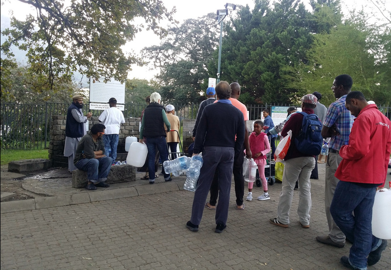 Capetonians queue up at local springs during the height of water restrictions in the city, when everything was being done to avoid the prospect of Day Zero when the taps would ultimately run dry. <b>Photo</b>&nbsp;<a href="https://www.flickr.com/photos/154236228@N02/28314612188/" target="_blank">Widad Sirkhotte, Flickr</a>.