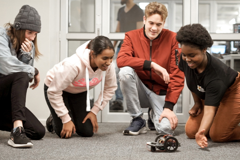 Learners at #RoboCampUCT watch one of their robots “come to life” and move around the laboratory.