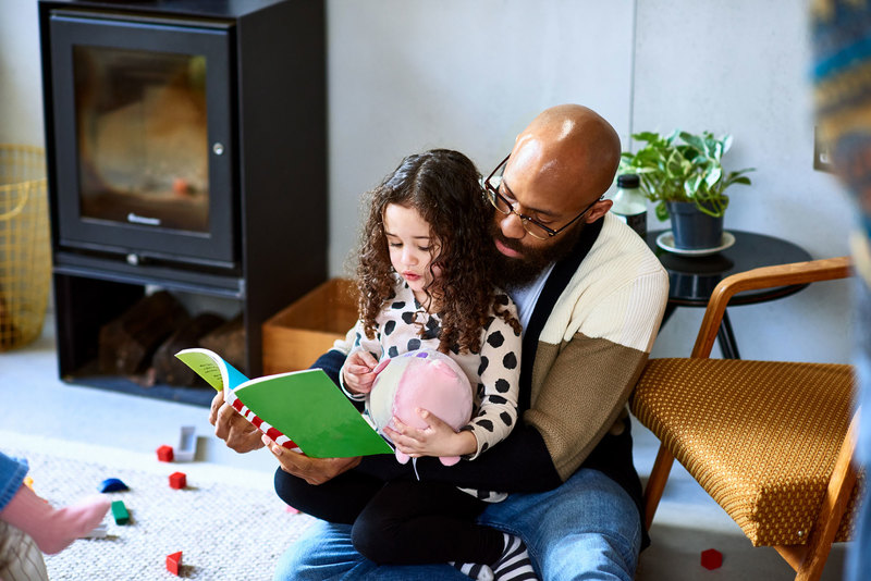 For nearly 30 years, a global movement has been encouraging men to be more involved with children &ndash; from conception to birth and beyond. <strong>Photo </strong><a href="https://www.gettyimages.com/detail/photo/man-reading-story-book-with-daughter-royalty-free-image/1223376543?adppopup=true&amp;uiloc=thumbnail_similar_images_adp" target="_blank">Getty Images</a>.