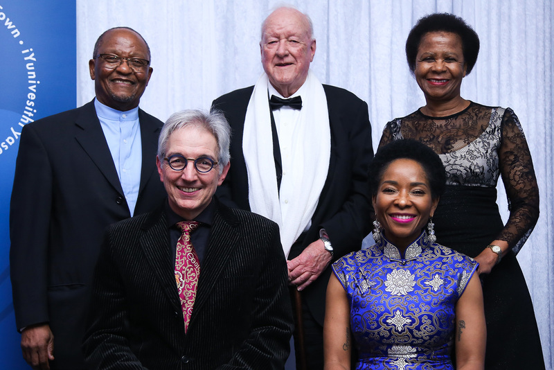 Dr Stuart Saunders (centre) next to Mamphela Ramphele (back right) and Prof Njabulo S Ndebele (back left) at the farewell gala dinner in 2018 for the outgoing vice-chancellor Dr Max Price (front left) and the incoming vice-chancellor Prof&nbsp;Mamokgethi Phakeng (front right). <strong>Photo</strong> Je&rsquo;nine May.