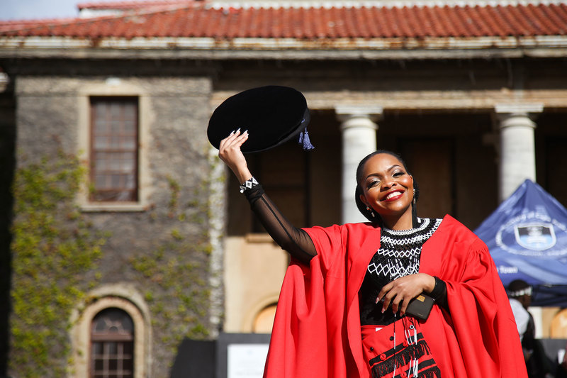  A jubilant PhD graduate celebrates outside the Sarah Baartman Hall on 22 July, the first live graduation in the hall since COVID-19 restrictions were lifted.