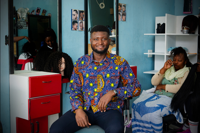 Ghanaian master’s student Bright Tetteh is co-founder of Learn a Skill, which teaches young, unemployed women in his country income-generating skills such as hairdressing, sewing and beadmaking. (Photos taken at a hair salon in Cape Town.)