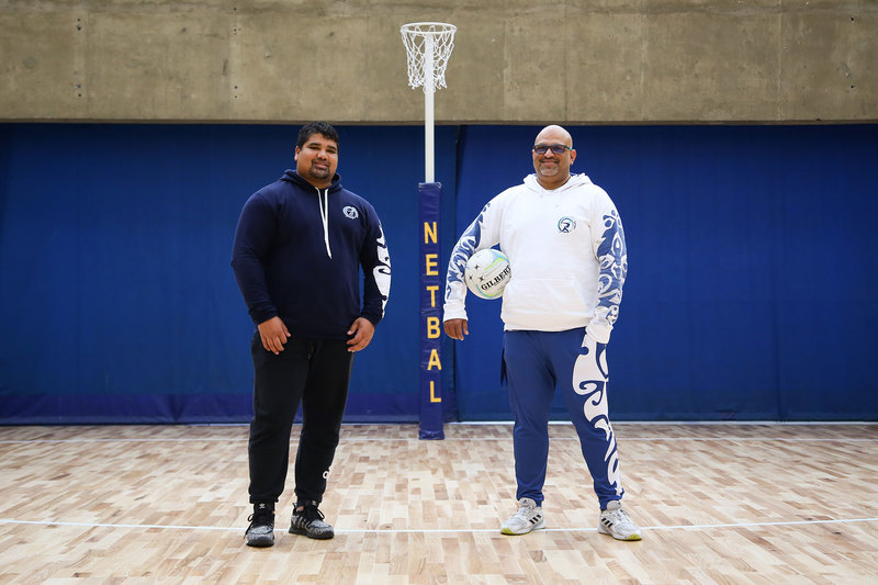 UCT Sports and Recreation’s Clement le Roux (sports coordinator for netball, among others) on the left, and Kiran Maharaj (senior sports coordinator) show off the temporary court surface in the Sports Centre, introduced for Netball World Cup Cape Town 2023 teams’ practice sessions. 