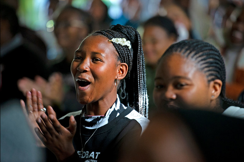 A young learner expresses her delight at hearing live opera at the Masiphumelele Library annex, thanks to partnership between EMS, UCT Opera and IkamvaYouth.