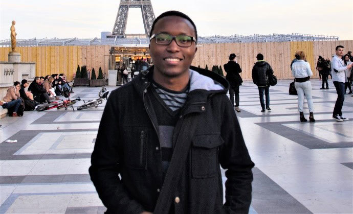 Musa in front of the Eiffel Tower.