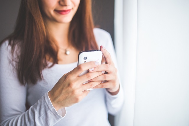 Sexting is a co-authored, negotiated experience that can empower young people. (Photo by <a href="https://www.pexels.com/photo/close-up-portrait-of-a-young-woman-typing-a-text-message-on-mobile-phone-6400/" target="_blank">Pexels</a>).