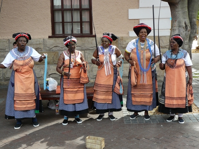 Five Xhosa women performing in traditional AmaXhosa costumes and face paintings at the Waterfront in Cape Town. Chell Hill / Commons Wikimedia.