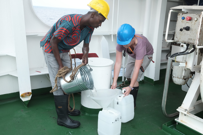 Vonica Perold (right), a doctoral researcher at the UCT FitzPatrick Institute of African Ornithology, and Manuel Taque (left), from the Mozambique Ministry of Sea, Inland Waters and Fisheries, sample seawater onboard the South African ship SA Agulhas II. <b>Photo</b> Peter G. Ryan. 