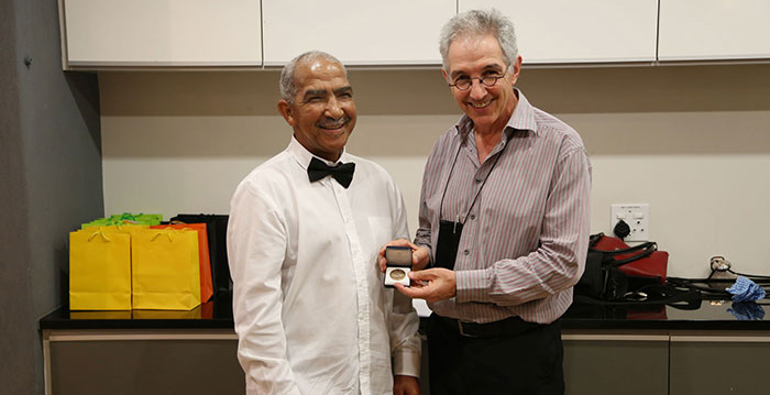 David Wilson, left, receives the Vice-Chancellor's Bronze Medal from Dr Max Price.