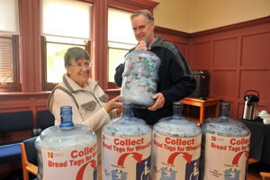 Grant Willis (right) hands over the bread tags to Mary Honeybun