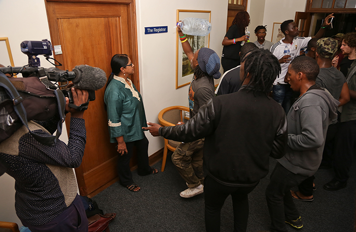 Students protesting outside the registrar&rsquo;s office on 23 March, with Dr Moonira Khan, director of UCT&rsquo;s Department of Student Affairs, in the doorway. Photo by Je&rsquo;nine May.