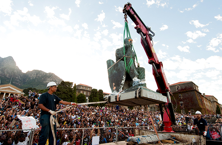 The roar of the crane&rsquo;s starter motor is drowned out by the roar of the crowd when they realise that the time for the removal of Rhodes&rsquo; statue had arrived. Photo by Roger Sedres.