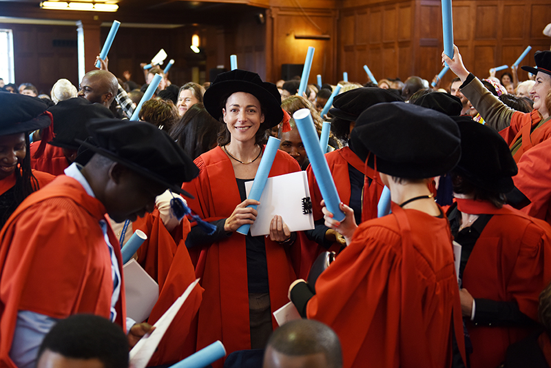 A flurry of red gowns at the July PhD graduation. More than 100 PhD graduands were capped at the ceremonies on Friday 14 July.