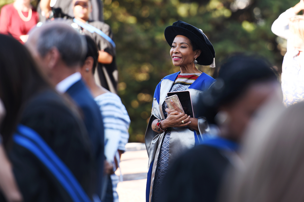 Deputy Vice-Chancellor Prof Mamokgethi Phakeng watches as graduates celebrate with their families.