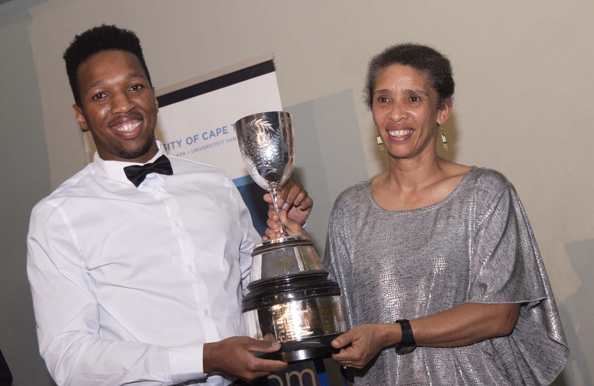 Edwina Brooks, director of Student Affairs, presents UCT sprint sensation Mpumelelo Mhlongo with the Jamison Cup for an incredible fifth consecutive year.