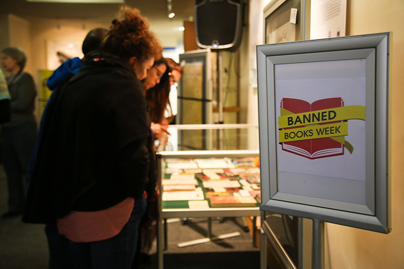 Guests at the exhibition examine some of the previously banned books that are on display