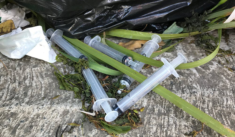 A collection of discarded syringes lies on the ground behind a row of shops in the suburb of Nahoon in East London. 