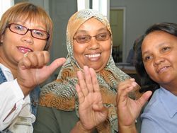 The A, B, C: (From left) Staffers Simona Adonis, Abiedah Abrahams, and Marie Pietersen flex their sign language alphabet skills.