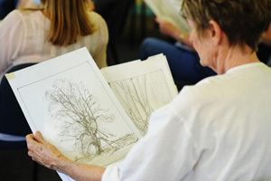 An eyeful: A botanical drawing student admires botanical illustrations by artist Dr Sarah Simblet.