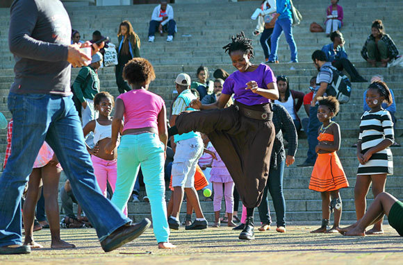 Assoc Prof Elelwani Ramugondo joins in a game of gqabu or rope-skipping on Jammie Plaza, as part of a demonstration of traditional African games hosted during Africa Month.