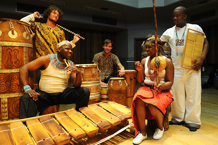 Some members of the Ibuyambo Orchestra travelling to Zurich. Front: Dizu Mzikantu Plaatjies (left), Nomapostile Nyiki, Keketso Bolofo. Back: Joseph Weinberg (left), Dylan Jefferies. Photo by Michael Hammond.