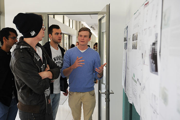 Bringing history to life: Stu Kelly (blue jersey) and Joe Davidson, two of the finalists in the design competition, explain their concept to visitors at the Heritage Day exhibition.