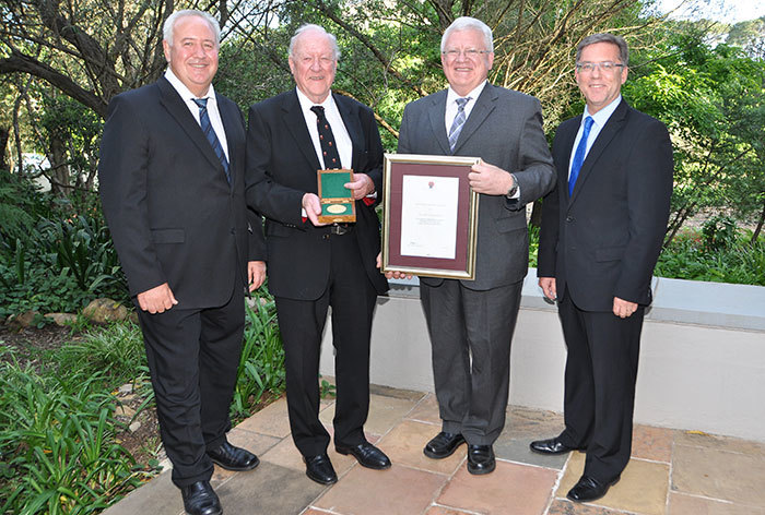 Prof Leopoldt van Huyssteen, Acting Rector at Stellenbosch University, (second right) presented the Pro Bene Merito Award to Prof Stuart Saunders (second left) at an event held at the Stellenbosch Institute for Advanced Study. They are flanked by George Steyn (left), Chairperson of the SU Council, and Prof Eugene Cloete (right), Vice-Rector: Research and Innovation.