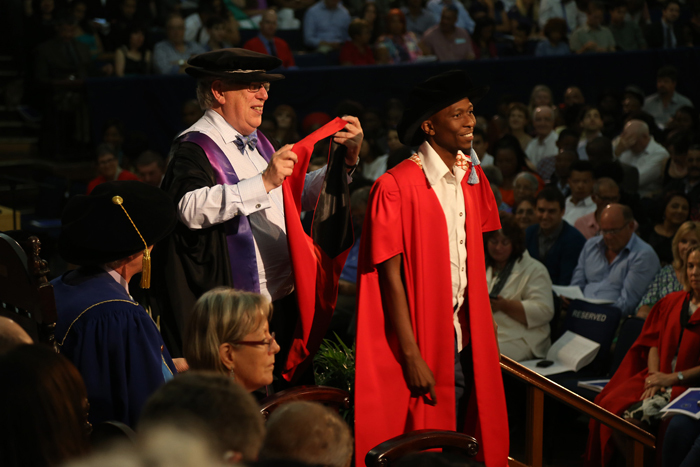 End of an era: Registrar Hugh Amoore hooding a PhD graduate at his last ceremony at 18h00 on 19 December, the closing ceremony of this year's abridged graduation season. Amoore is UCT's longest-serving registrar.