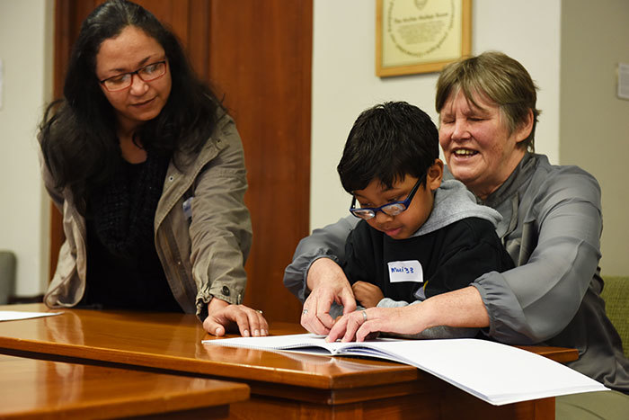 Director of UCT's Disabilities Service Reinette Popplestone (right) and manager of LOFOB's early childhood development programme Benita Petersen with an eager young reader.