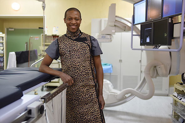 Part of Dr Ntobeko Ntusi's work is in the cardiac catheterisation laboratory, where he performs invasive coronary angiography and other forms of angiographic-based cardiac imaging. These angiographic methods require fluoroscopic guidance (fluoroscopy is continuous x-ray imaging). He wears the lead apron to protect against ionising radiation related to x-rays, which increases the risk of cancers.