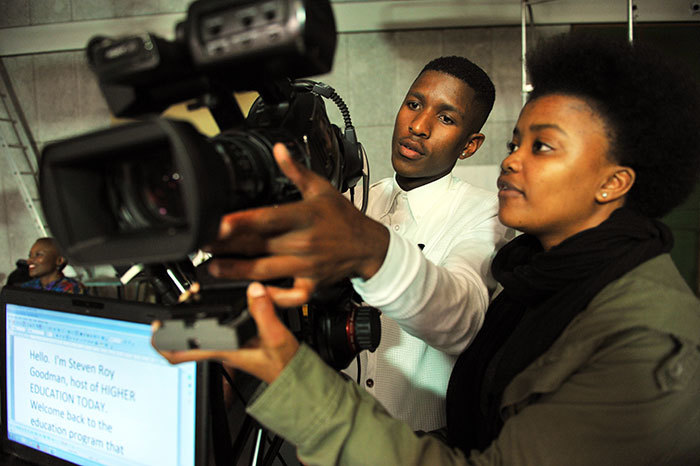 Thabo Skotoyi and Asiphe Saul of the Stepping Stone video production team setting up a camera before the shoot.
