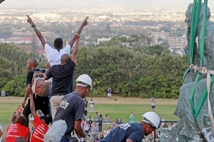 Rhodes is removed from its plinth on upper campus, and students rise to take his place. Photo by Nardus Engelbrecht.